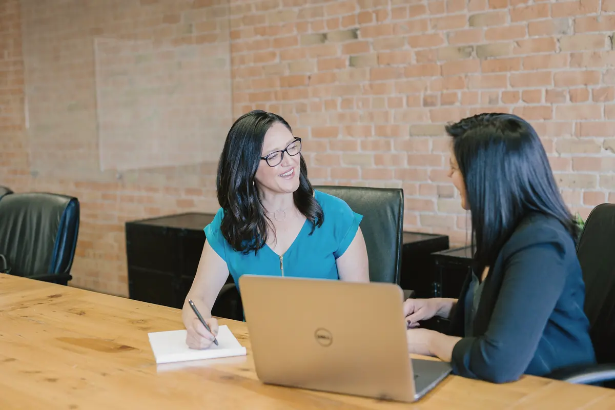 A lawyer meeting with a client at a wooden table