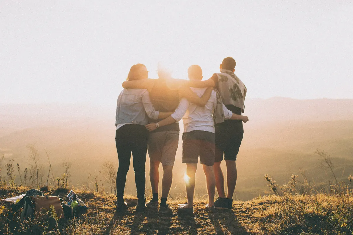 A family standing together at sunset